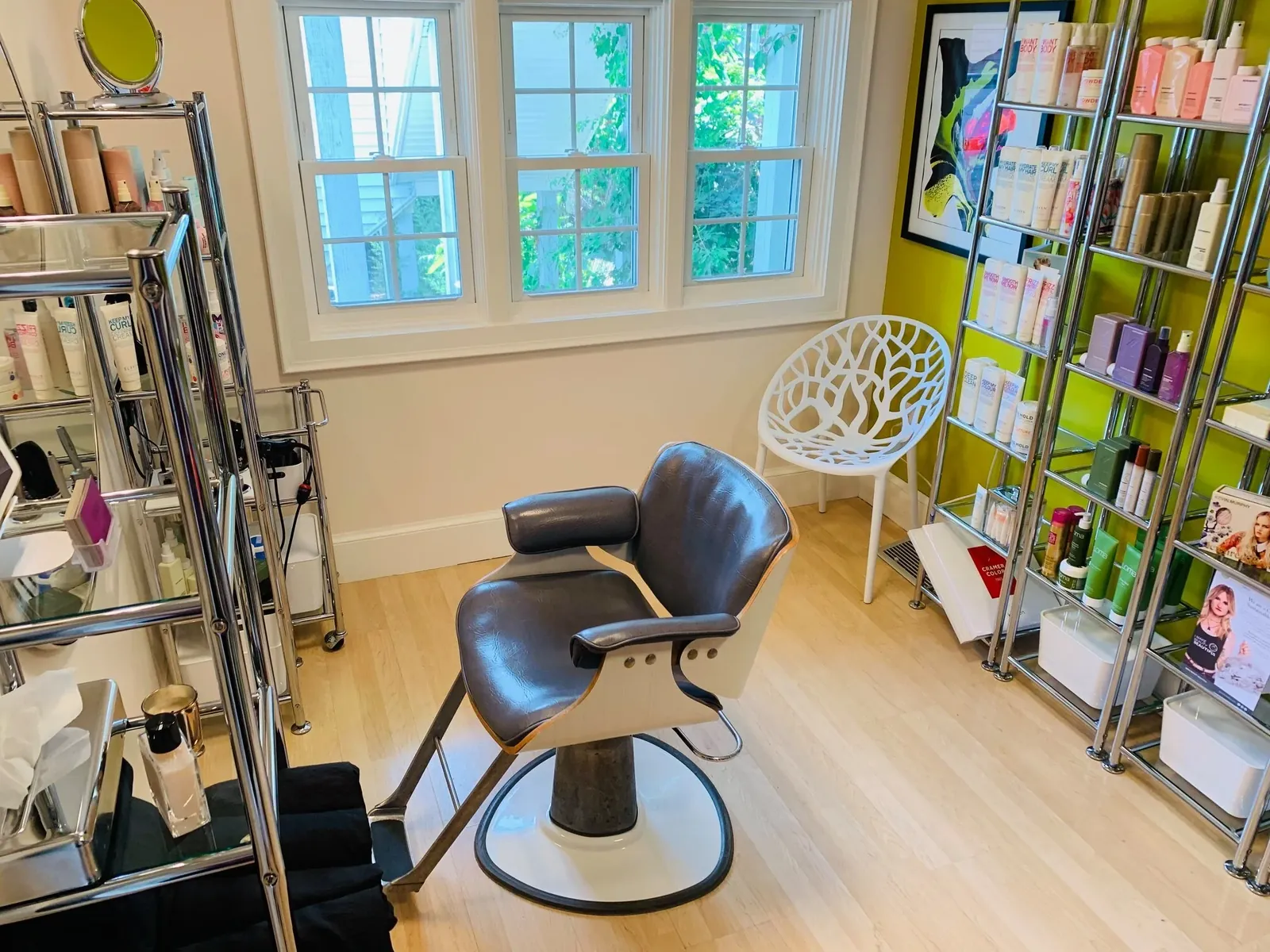 A leather styling chair and shelves of hair products inside Euphoria salon