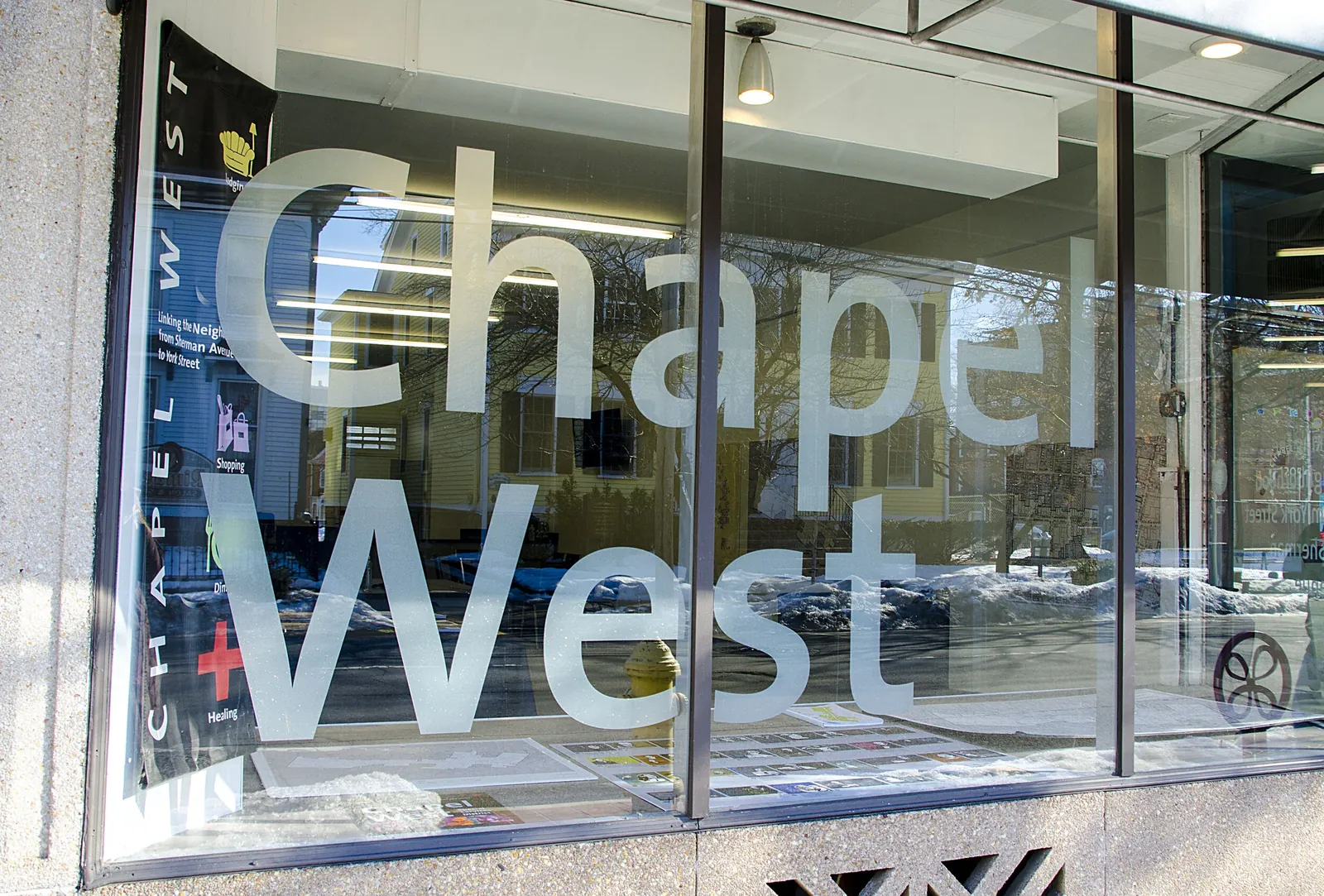 Chapel West lettering etched across the glass front of a Chapel Street storefront