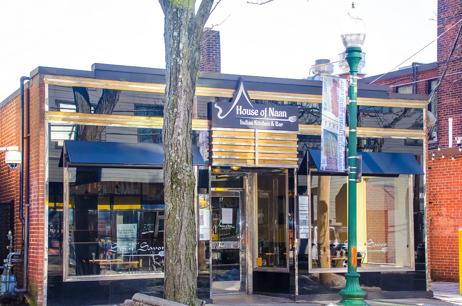 House of Naan's blue awnings and glass frontage beside a Chapel Street lamppost