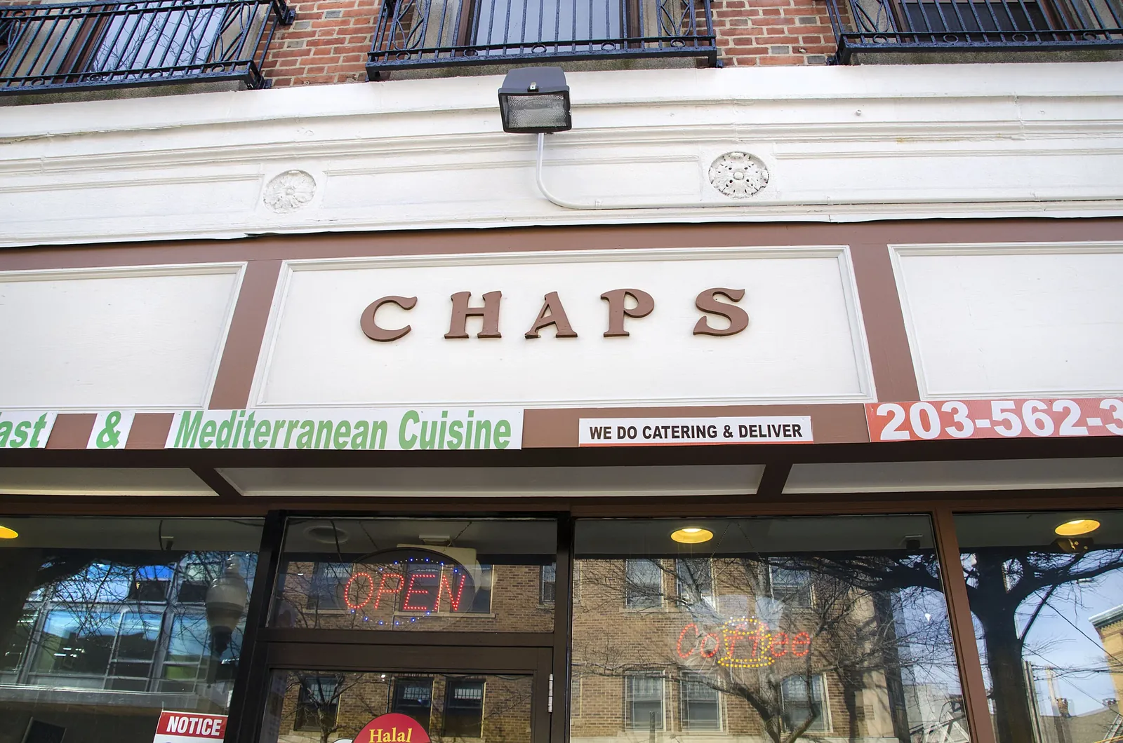 The sign and awning above Chap's Grille, advertising Mediterranean cuisine and catering